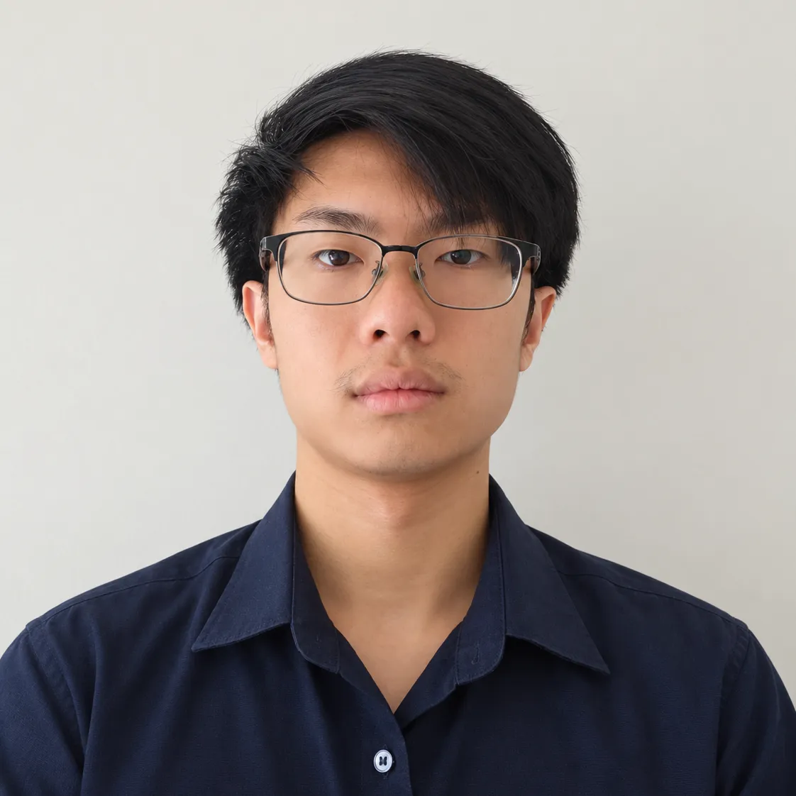 Front-facing photo of Web in a navy shirt